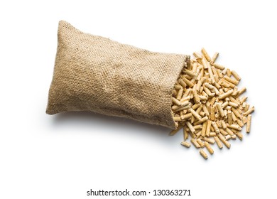 wooden pellets in jute sack on white background