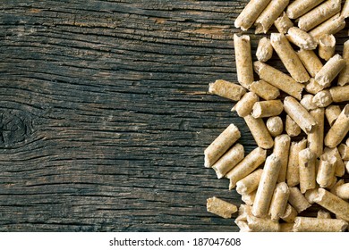 the wooden pellets on old wooden background