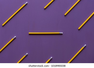 Wooden Pencils With Eraser Tops Arranged Parallelly And Only  One In Horizontally, Out Of Context, With Space For Text, On A Purple Background.