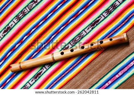 wooden peruvian flute with traditional cloth