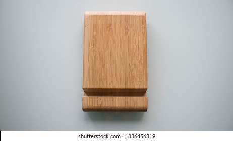 A wooden phone stand, a phone holder on white background