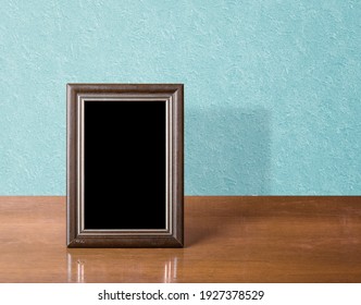 Wooden Photo Frame On Table, Blue Wall