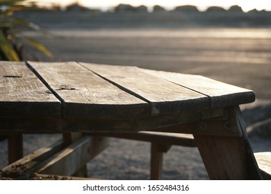 Wooden Picknick Table In The Middle Of Nowhere With Sunset