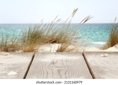 Wooden Picnic Table Background Mockup On The Beach, Next To The Ocean.
