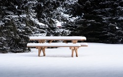 A Wooden Picnic Table At A Public Park Covered In Deep Snow On A Late Winter Day In Calgary Alberta Canada