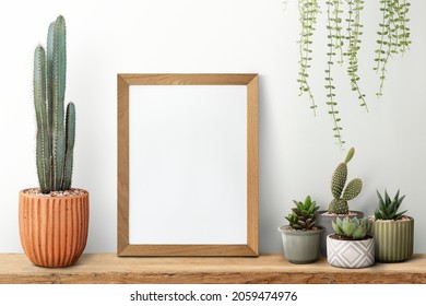 Wooden Picture Frame On A Shelf With Cactus
