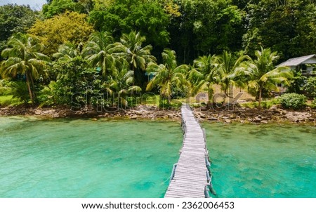 wooden pier at Bang Bao Beach Koh Kood Island Thailand Trat , tropical beach with palm trees and a turqouse colored ocean on a sunny day, Ko Kut Island 
