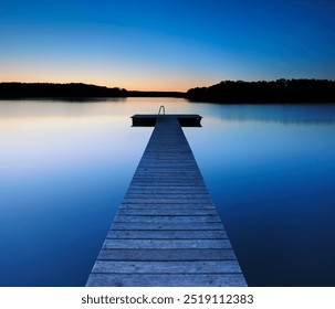 Wooden Pier by Calm Lake at Dusk - Powered by Shutterstock