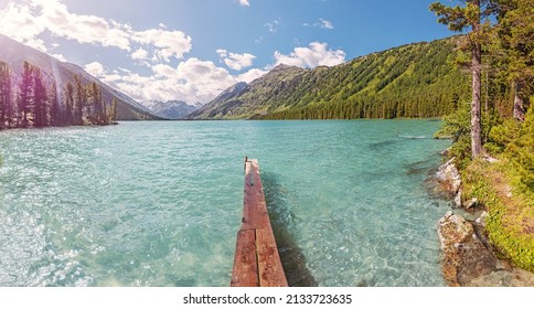 Wooden Pier For Fishing Boats On A Scenic Mountain Lake. Fishing In National Park