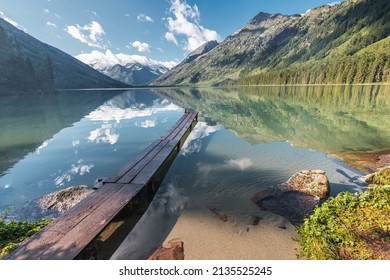 Wooden Pier For Fishing Boats On A Scenic Mountain Lake. Fishing In National Park