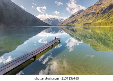 Wooden Pier For Fishing Boats On A Scenic Mountain Lake. Fishing In National Park