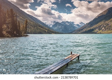 Wooden Pier For Fishing Boats On A Scenic Mountain Lake. Fishing In National Park