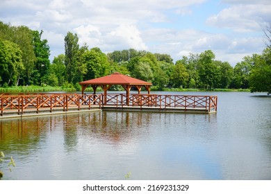 Wooden Pier And Gazebo On The Pond