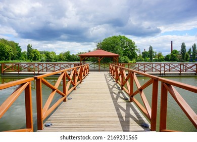 Wooden Pier And Gazebo On The Pond