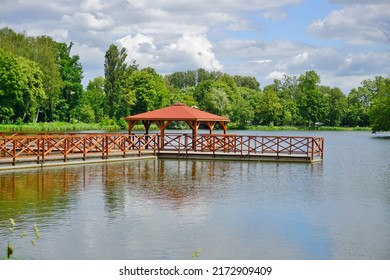 Wooden Pier And Gazebo On The Pond