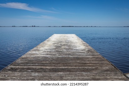 Wooden Pier In A Lagoon. Wooden Surface To Get Away From The Shore.