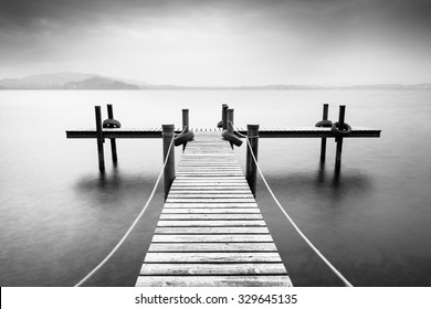 Wooden pier on the lake. Fog. Long exposure. Black and White. - Powered by Shutterstock