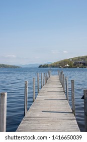 Wooden Pier On Lake In Quaint New England Town