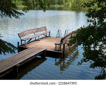 Wooden Pier On The Lake, Selective Focus. Concept Of Summer Outdoor Recreation. Harmony Of Nature