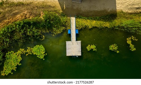 Wooden Pier On Lake With  Water Liliesnymphea Aerial View