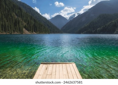 wooden pier on a mountain lake with turquoise clear water. Lake Kolsai or Kulsay in the mountain range of Kazakhstan - Powered by Shutterstock