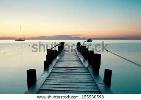 wooden pier on Tyrrhenian sea near Naples in summer morning 