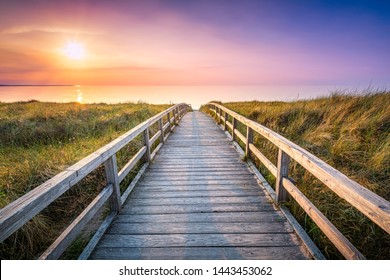Wooden pier at sunset along the dune beach, North Sea, Germany