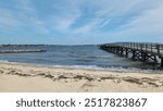 Wooden pier at Yorktown Beach in York County, Virginia is a popular tourist attraction.