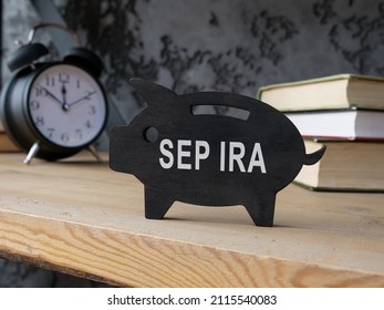 Wooden Piggy Bank With SEP IRA Inscription On The Side.