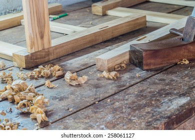  wooden plane in a workshop of the carpenter with curls of wood shavings