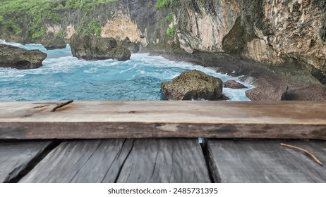 wooden plank overlooking a beautiful ocean scene with crashing waves, rocky cliffs, and lush greenery. 
 - Powered by Shutterstock