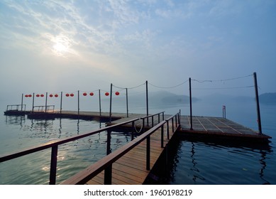 Wooden plank road and red lanterns at the lake pier - Powered by Shutterstock