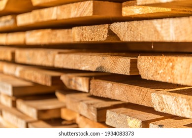 Wooden planks and beams. Air-drying timber stack. Wood air drying. Wood for house construction. Building material. Wood warehouse. - Powered by Shutterstock