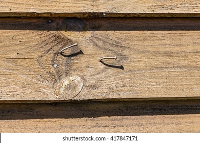 Wooden planks with nails hammered. Bent old nails on wooden boards
