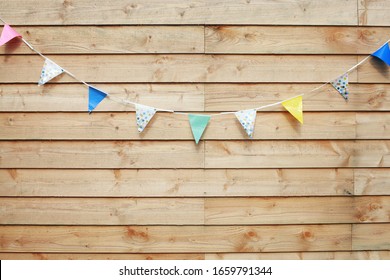 Wooden Planks Wall Background With A Birthday Party Flags Slinger