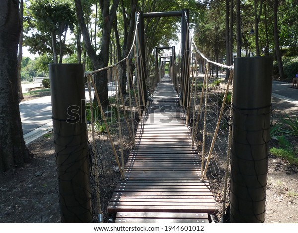 Wooden play rope bridge\
in public park