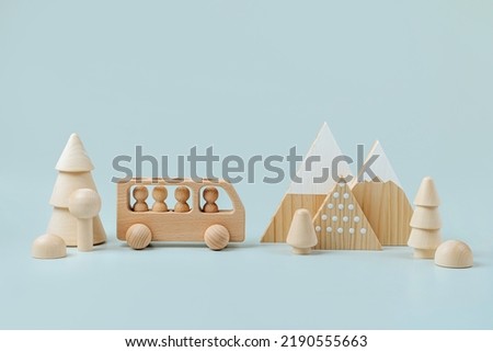 Wooden play set forest, mountains and a bus on a blue background. Games for learning and development of the child. Cute kids toys  for decorating children's room. 