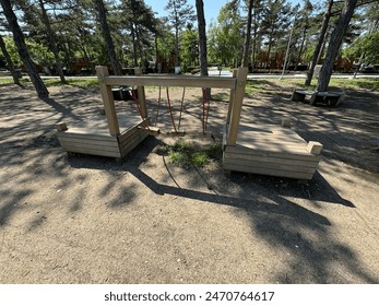 Wooden playground bridge. Children playground with modern slide, rope net bridge, climbing swings, climbers. Empty wooden playground made of eco materials. - Powered by Shutterstock