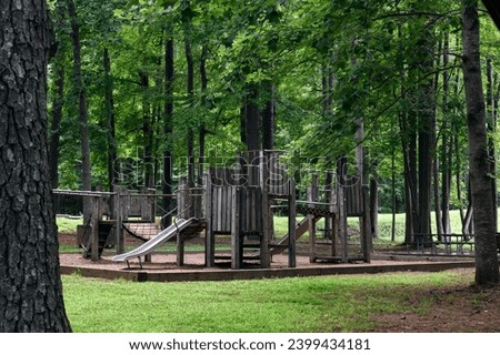 Wooden playground surrounded by oak trees at Landsford Canal State Park. 