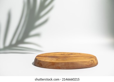Wooden podium with leaves shadows. Realistic wood platform for product presentation. Minimal nature scene with pedestal mockup. cosmetic display or award ceremony