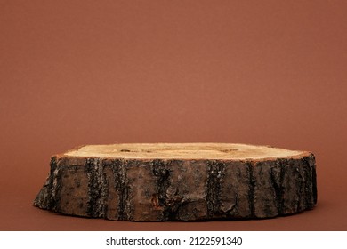 wooden podium or one saw cut on brown background, background for cosmetic products - Shutterstock ID 2122591340