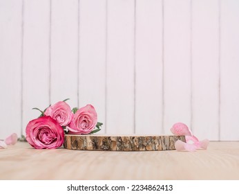 Wooden podium or product stage with pink roses on white wooden background.  - Powered by Shutterstock