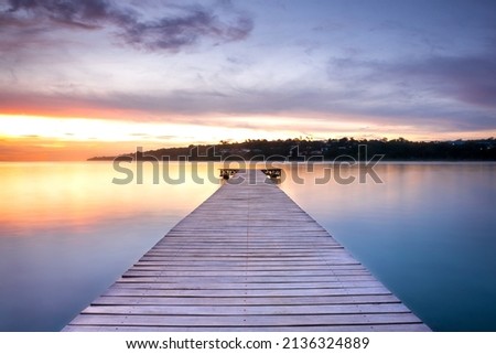 Wooden pontoon over the water sunset Stock foto © 