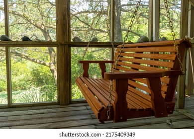 A Wooden Porch Swing In A Beach House On The Outer Banks.