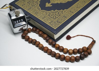 
Wooden prayer beads, hand tally counters and the Koran as a medium for praying closer to Allah SWT. - Shutterstock ID 2027727839
