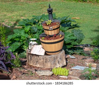 A Wooden Pump Style Fountain Has Been Turned Into The Focal Point Of A Backyard Garden In Southwest Missouri For A Unique Ornament Of Interest. Bokeh Effect.