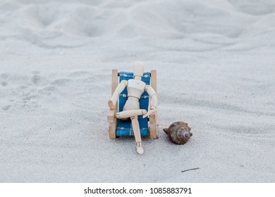 Wooden puppet at the beach - Shutterstock ID 1085883791