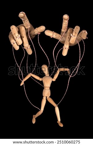Wooden puppet doll, obeying master  hand pulling the strings of dancing marionette. Concept of emotional manipulation, world conspiracy theories., control and dictatorship