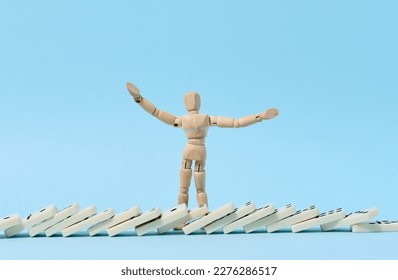 Wooden puppet and fallen domino, concept of failure and collapse - Shutterstock ID 2276286517