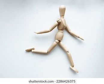 Wooden puppet in sports poses - Powered by Shutterstock